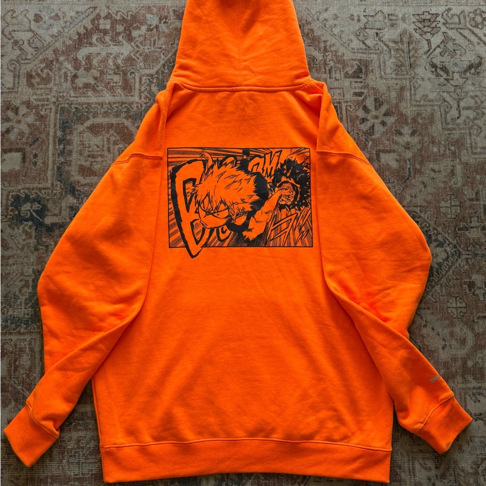 Vibrant Orange Sweater with Bold Black Graphic